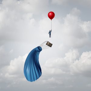 Hot air balloon sinking while business man, holding on to a smaller balloon, soars, showing budget control can save businesses.
