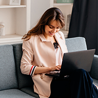 Woman working from home on laptop happy that she has access to her files