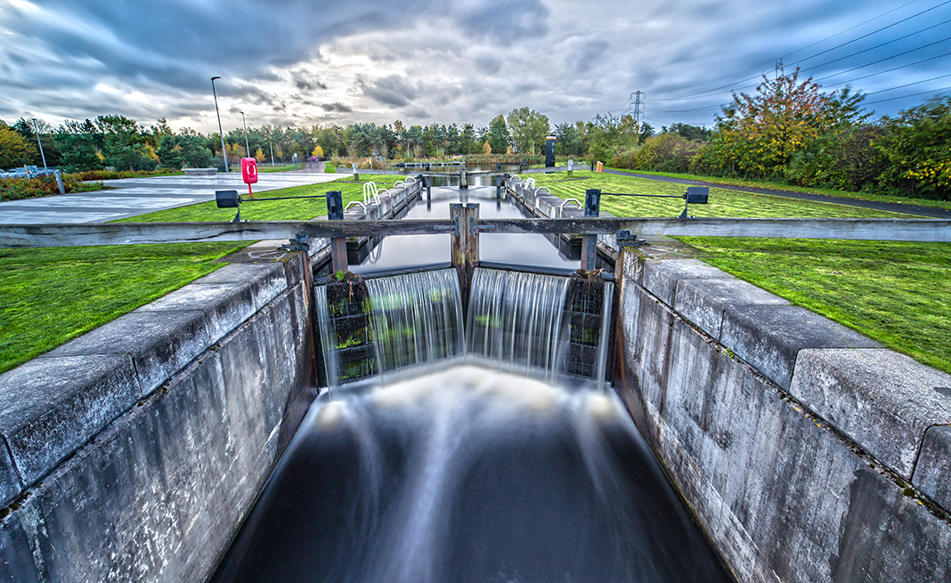 An image showing a lock releasing water on Caledonian Canal, indicating growth.